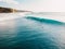 Aerial view with surfers and barrel blue wave in ocean