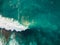 Aerial view of surfers and barrel wave in blue ocean. Surfer on wave. Top view