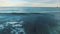 Aerial View. Surfers swim in the ocean at sunset.