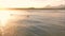 Aerial View. Surfers swim in the sea at sunrise