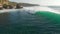 Aerial view of surfers and wave in tropical ocean. Top view