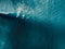 Aerial view of surfing at perfect barrel waves. Blue waves and surfers in ocean