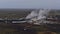 Aerial view of Svartsengi geothermal power plant with pipelines for hot water and steaming stacks near Grindavik, Iceland.