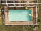 Aerial view of swimming pool with animal and fruit shapes mats.