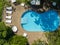 Aerial view of a swimming pool, relaxation and resort, benches and seating.