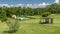 Aerial view of a swimming pool surrounded by the greenery of Tuscany, Italy, with movement of clouds in time lapse