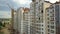 Aerial view of tall residential building under construction in a city.