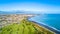 Aerial view on Taranaki coastline with a small river and New Plymouth and Mount Taranaki on the background. New Zealand