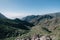 Aerial View of Tenerife overlooking a green mountain valley with a ocean view