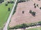 Aerial view Texas farmland prairie field bale hay on sunny day