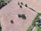 Aerial view Texas farmland prairie field bale hay on sunny day