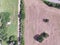 Aerial view Texas farmland prairie field bale hay on sunny day