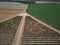 Aerial view of textures. Rows of soil with plantations. Pattern rows of furrows in a plowed field prepared to plant crops in sprin