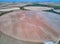 Aerial view of textures. Rows of soil with plantations. Pattern rows of furrows in a plowed field prepared to plant crops in sprin