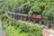 Aerial view of Thai local old classic train on railway on River Kwai Bridge in Kanchanaburi town, Thailand in public