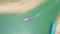 Aerial view of Thai traditional longtail boat sailing through waterway channel made in sand beach