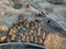 Aerial view of three multi-colored dump tip trucks unloading in