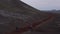 Aerial view three traveler adventurous hikers walking pathway in desert landscape in Iceland. Drone point of view of