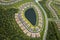 Aerial view of tightly located family houses with retention ponds to prevent flooding in Florida closed suburban area