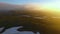Aerial View. timelapse. Fast flying over the green valley. Sunset in the mountains.