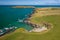 Aerial view of a tiny sandy beach surrounded by cliffs on the coast of Wales Gwbert, Pembrokeshire
