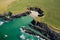 Aerial view of a tiny sandy beach surrounded by cliffs on the coast of Wales Gwbert, Pembrokeshire