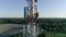 Aerial view to cellular antenna, radio master working at telecommunications tower dressed on hard hat