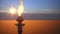 Aerial view to gas flare stack of petroleum refineries sunset background, flare pit tower