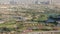 Aerial view to Golf course with green lawn and lakes, villa houses behind it timelapse.