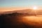 Aerial view to misty orange fog with path and hill at sunrise, Czech landscape