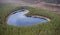 Aerial view to the natural heart-shaped forest lake on Parika nature reserve, Viljandi, Estonia