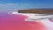 aerial view to pink lake with salt shore with little islands with copy space in Ukraine