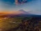 Aerial view to rice terrace and Mount Agung. Amazing orange and purle sky lights with clouds.
