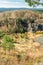 Aerial view to swamped quarry with high dry grass and rock, Czech republic