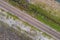 Aerial view top down photo from flying drone of asphalt road around the dam and people running exercise on the road in the morning