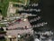 Aerial view from top down. pier with boats and yachts in dark water. Lake or sea