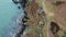 Aerial view top down shot of sea shore,stony rocks and giant cliffs with breaking ocean waves in ireland