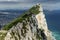 Aerial view of top of Gibraltar Rock, in Upper Rock Natural Reserve: on the left Gibraltar town and bay, La Linea town in Spain an