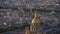 Aerial view of the top of Les Invalides dome with golden colored cupola located in the dense historic center of Paris.
