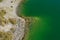 Aerial view or top view, showing a part of the Quilotoa lake which is chemical green due to the vulcanic substrate of this crater