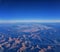 Aerial view of topographical Rocky Mountain landscapes on flight over Colorado and Utah during autumn. Grand sweeping views of riv