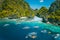 Aerial view of tourist boats in front of big Lagoon at Miniloc Island, El Nido, Palawan, Philippines. Surreal karst