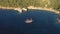 Aerial view of a tourist cruise ship sailing near the rocky Mediterranean coast of the Greek island of Thassos