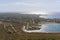 Aerial view on touristic town on Mediterranean sea. Small organized beach on peninsula.
