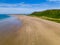 Aerial view of tourists on a huge, wide sandy beach on the coast of Wales Rhossili, Wales