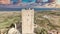 Aerial view of tower castle and medieval town with valley and sea - Posada, Sardinia