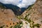 Aerial view of towering, cloud covered mountains at the exit of the Samaria Gorge Agia Roumeli, Crete