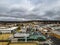 Aerial view of the town of Armidale with old buildings and parked cars under a gray cloudy sky