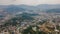 Aerial view of a town with buildings among hills in Thailand. Asia. Drone.