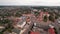 Aerial view of the town center and new buildings and private courtyards on the outskirts on a summer day